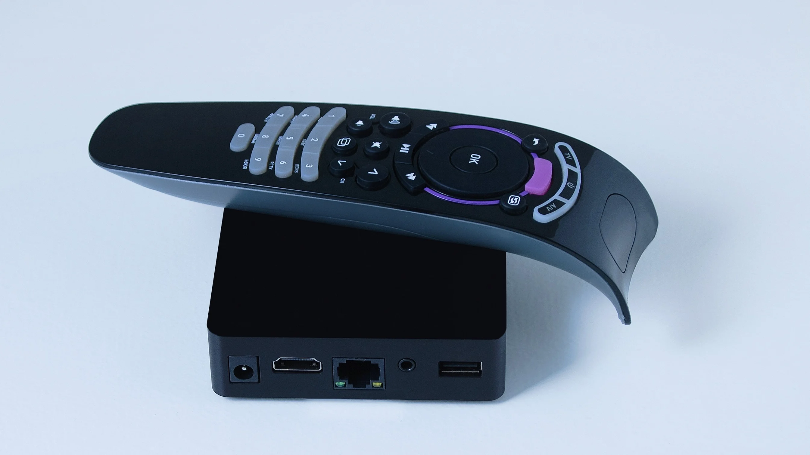 Streaming box and remote control on a white surface